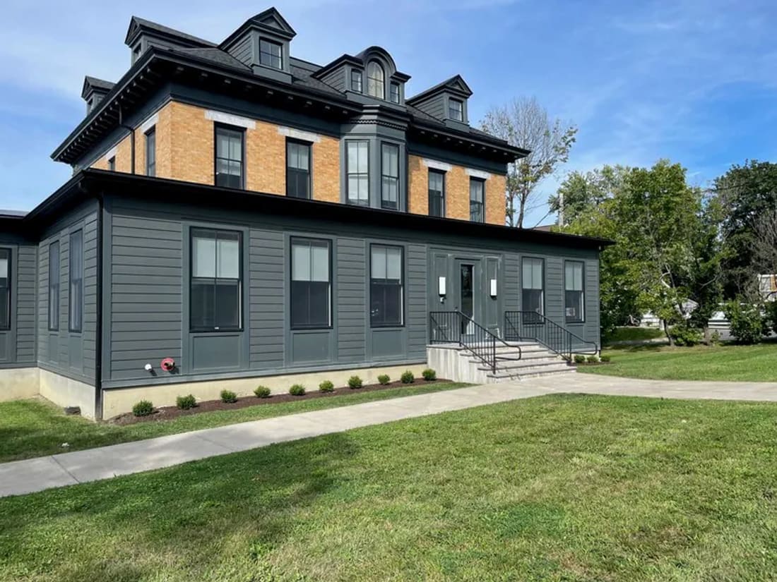 The Columbia Medical Care office at 886 Columbia Street in Hudson, New York: a brick and grey clapboard building with a front entrance and steps